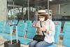 Lady at airport terminal with mask on
