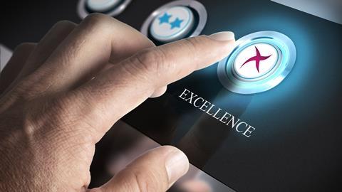 A finger on an 'excellent' button on a keypad