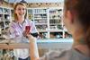 Woman paying for items in deli