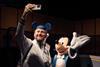 Man taking a selfie with Mickey Mouse at the Disney100: The Exhibition