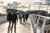 Fans walking across the bridge to the Etihad Stadium, home to Manchester City FC.