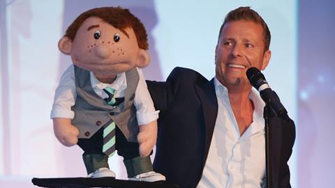 Ventriloquist Paul Zerdin with his puppet Sam on stage