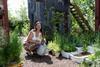 Frances Tophill watering plants in the garden.