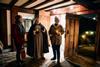 Costumed guide shows guests around Shakespeare's Birthplace Trust by candle light in Stratford-upon-Avon.