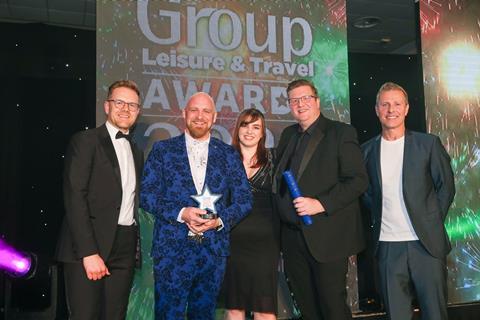 Josh Behn of Disney Tickets (left) and Paul Zerdin (right) present the GLT Award to The Royal Mint Experience team.