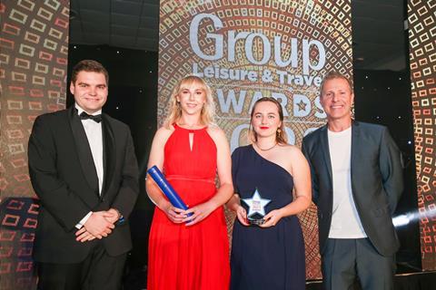 Rupert Viney from Legoland® Windsor Resort (left) presents the award to Alex Dixon and Isobel Gomer from Historic Royal Palaces, alongside host Paul Zerdin.