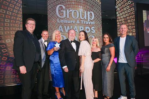 Paul Brandwood of The Royal Mint Experience presents the award to Colin Duncan (centre) and the rest of the Dunwood team, alongside host Paul Zerdin.