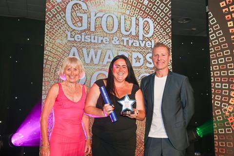 Marian Durbidge of the New Meridian Association presents the award to Chadia Self from the Tottenham Hotspur Stadium, alongside host Paul Zerdin