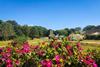 Vibrant flowers frame a view of Rushen Abbey on the Isle of Man
