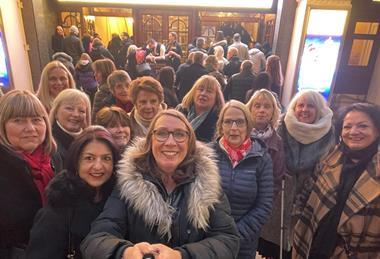 Members of Theatre Trips Essex outside the London Palladium before a show