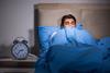Young man scared in bed