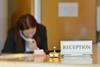 A receptionist on the phone at a hotel desk